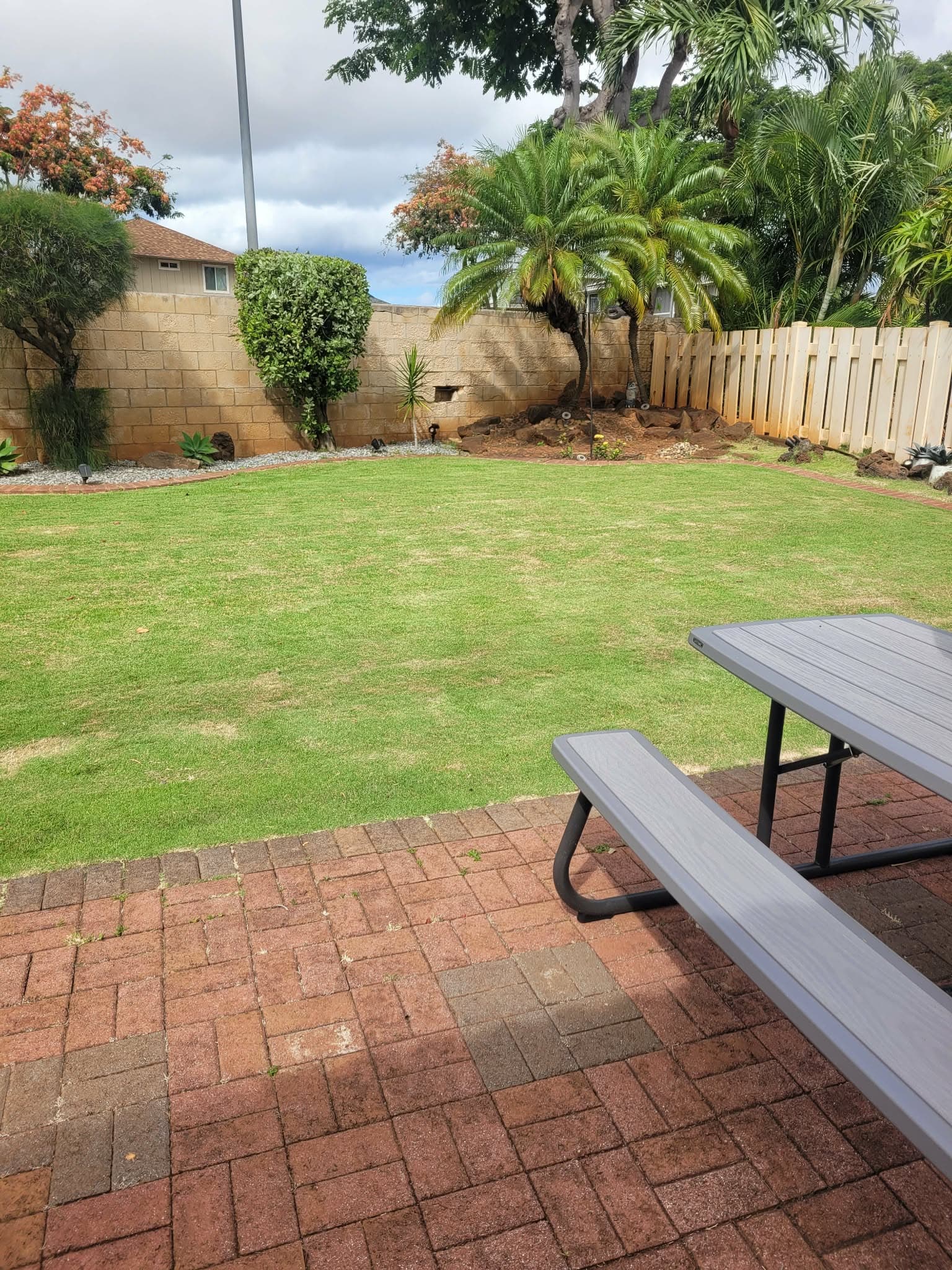 Freshly mowed backyard lawn with paver patio